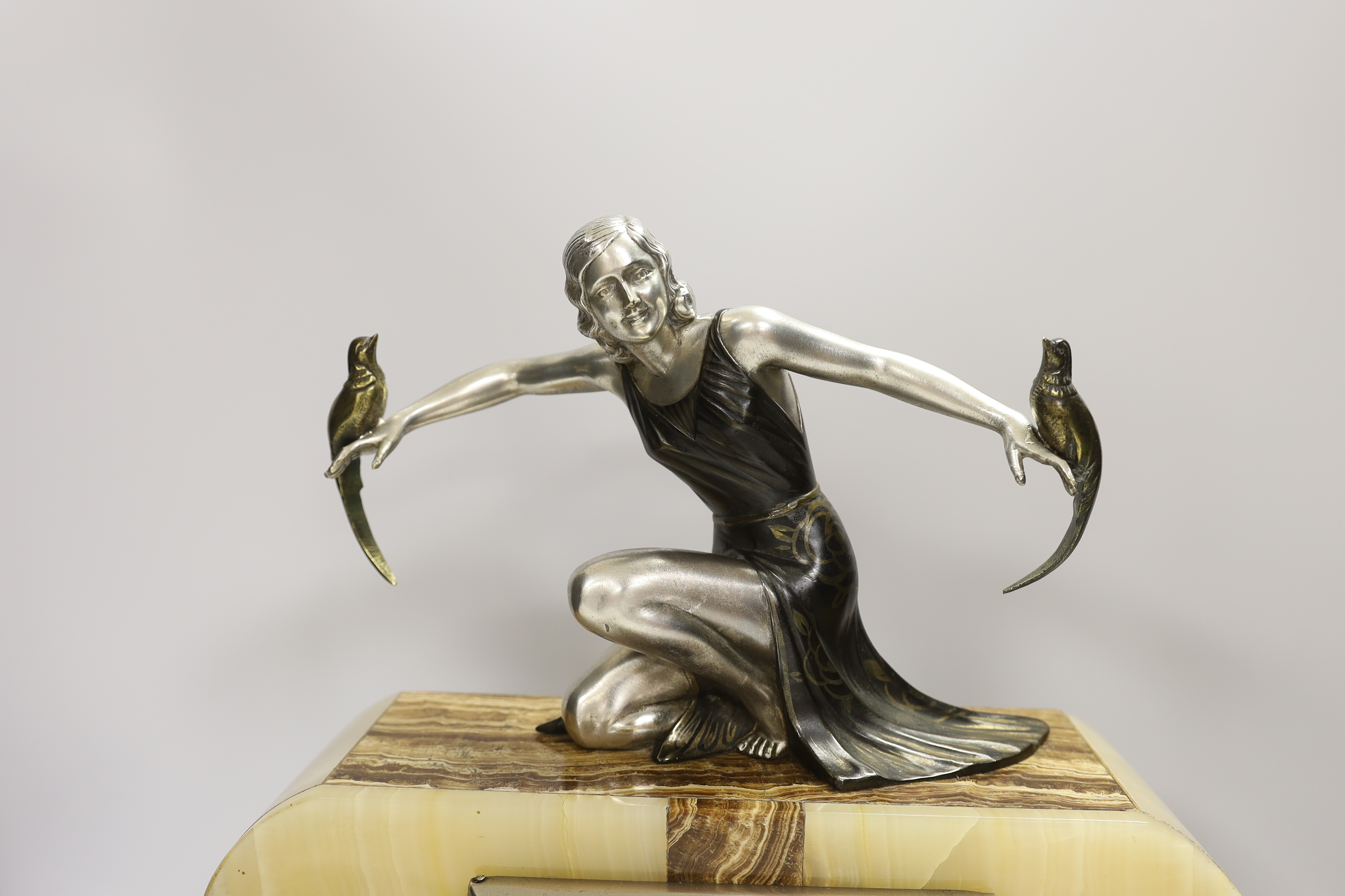 A French Art Deco onyx and spelter mantel clock, signed S. Moralni, with key and pendulum, 39cm